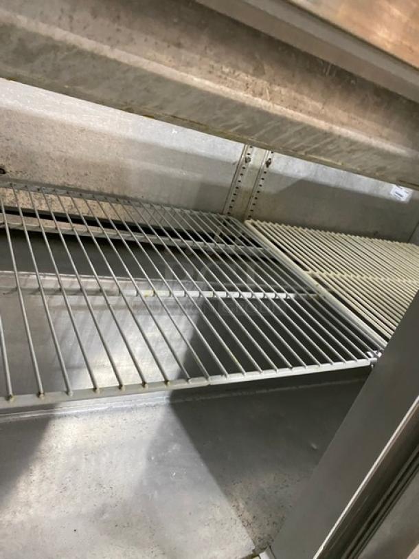 Continental stainless steel refrigerated bain marie prep table; two doors, poly-coated wire racks, on casters.