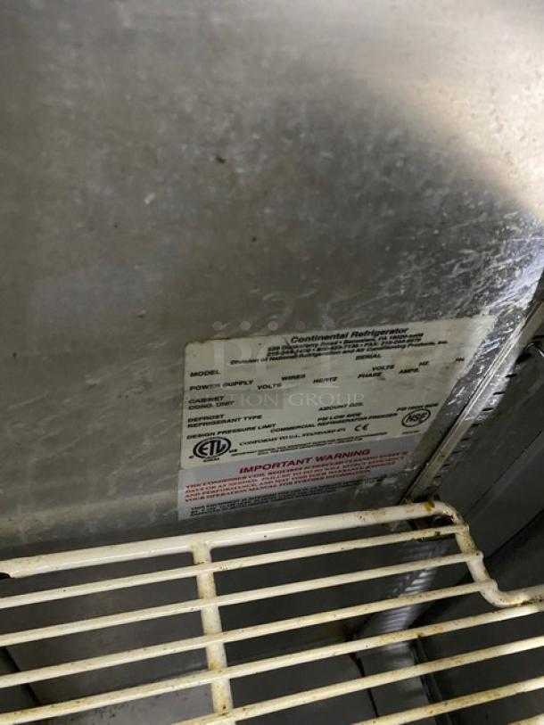 Continental stainless steel 2-door refrigerated prep table with poly-coated wire racks, on casters. Visible label shows specs.