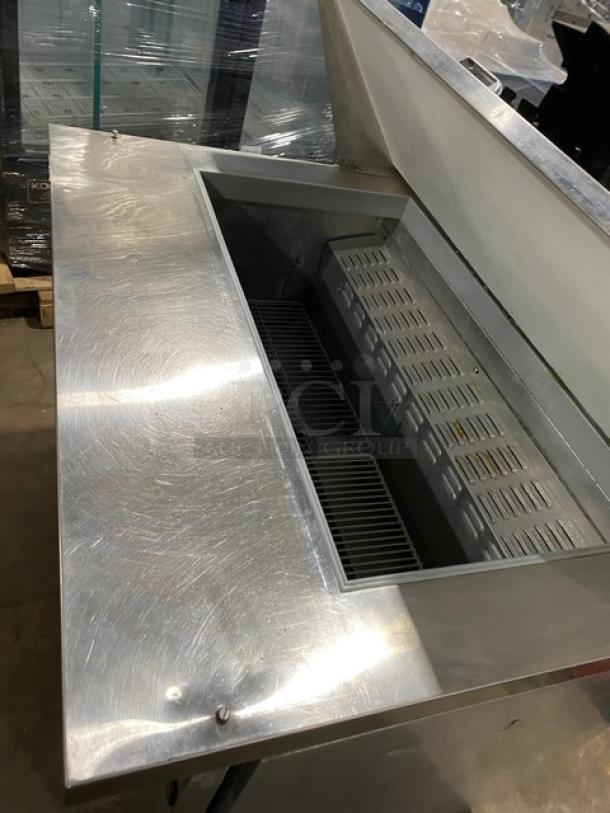 Continental stainless steel 2-door refrigerated bain marie prep table with poly coated wire racks, on casters, used condition.