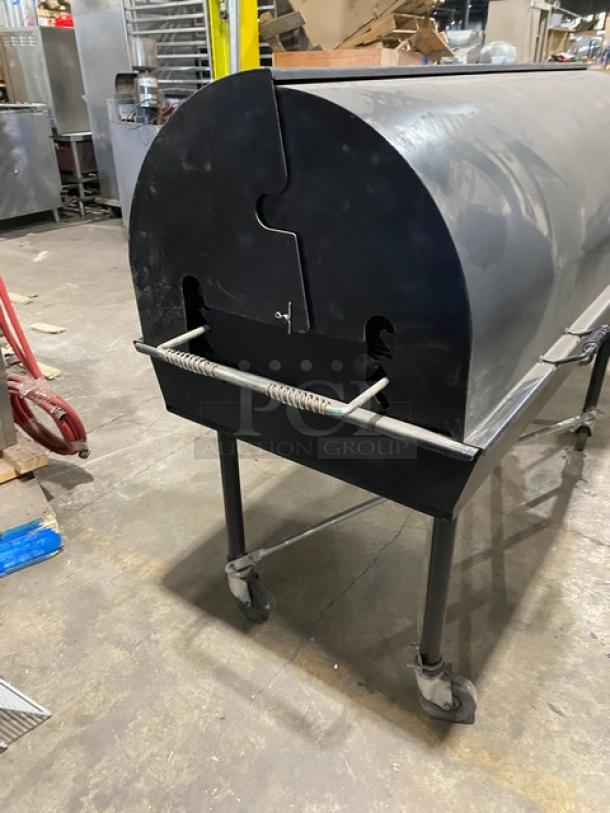 Porta-Grill PG2460II black liquid propane BBQ grill on casters. Features durable design, excellent condition for outdoor use.