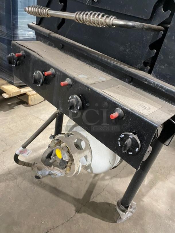 Porta-Grill PG2460II black propane BBQ grill, on casters, with control knobs, propane tank holder, slightly dusty.