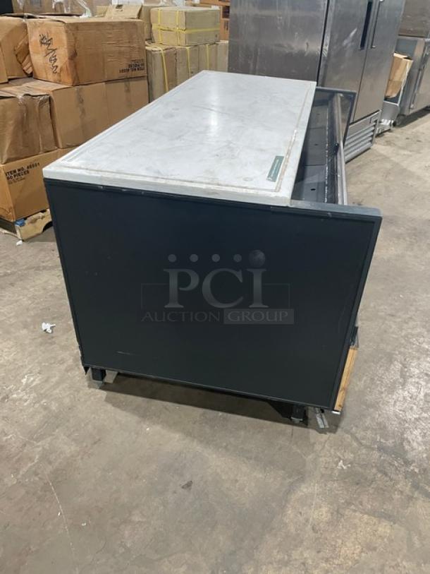 Structural Concepts black refrigerated open merchandiser display case, model SBZ6652DR. On legs, 220V 1 Phase. Used condition.