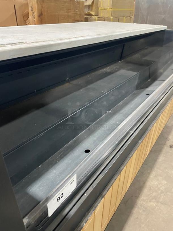 Structural Concepts SBZ6652DR black refrigerated open merchandiser on legs. 220V, 1 Phase, good condition, shelves visible.