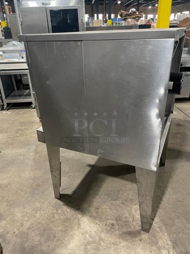 SunFire stainless steel natural gas convection oven model SCOGS10S on legs, showing rear view and wired racks.
