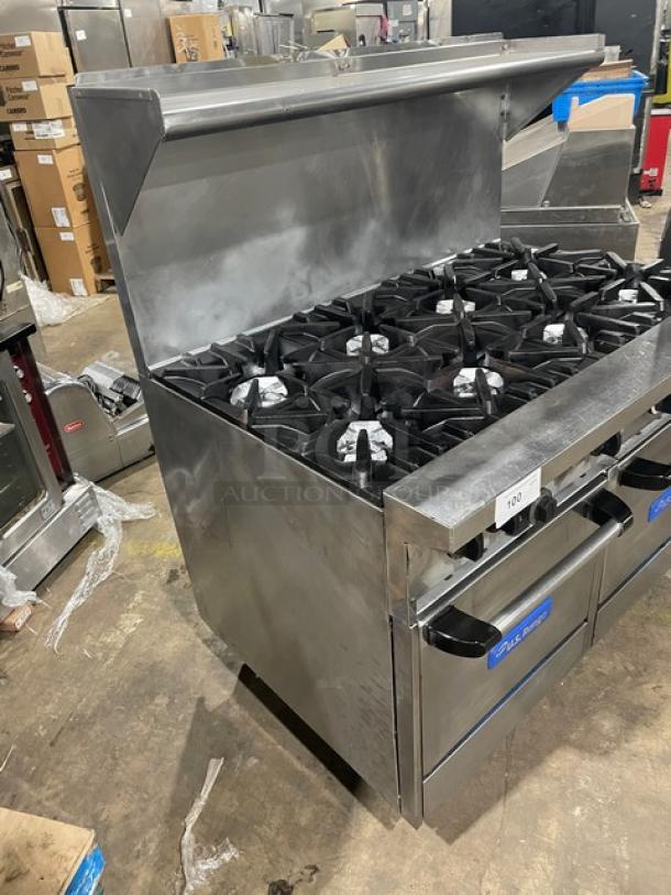 U.S. Range commercial stainless steel 8-burner range, double oven combo, with backsplash, overhead salamander shelf, on legs.