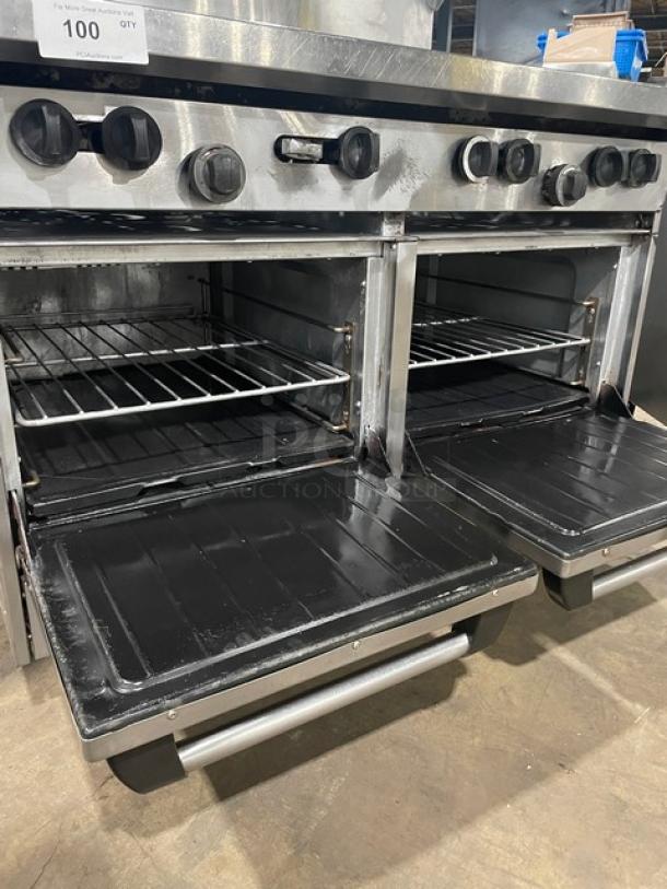 U.S. Range stainless steel 8-burner range with double ovens, backsplash, overhead salamander shelf, and wired oven racks.
