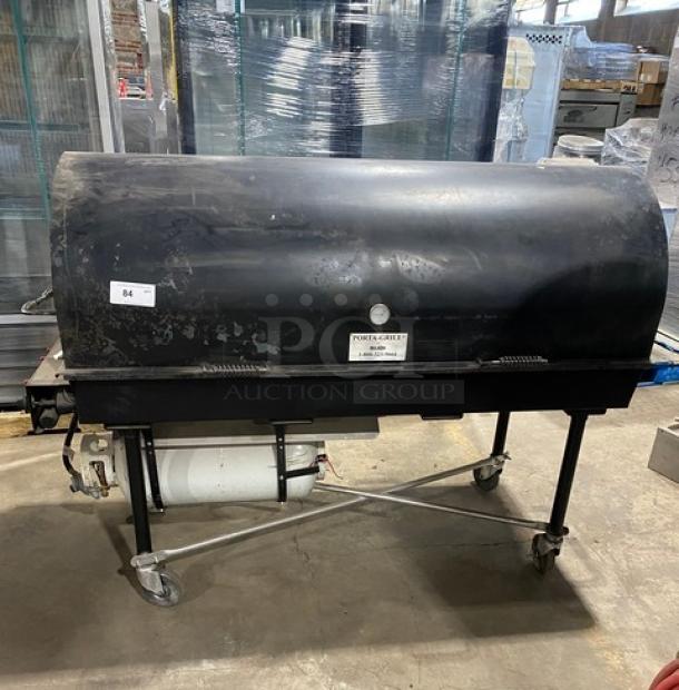 Porta-Grill PG-2460-II propane outdoor BBQ grill, black, on casters, commercial-grade, visible wear, includes propane tank.