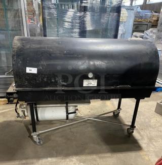 Porta-Grill PG-2460-II propane outdoor BBQ grill, black, on casters, commercial-grade, visible wear, includes propane tank.