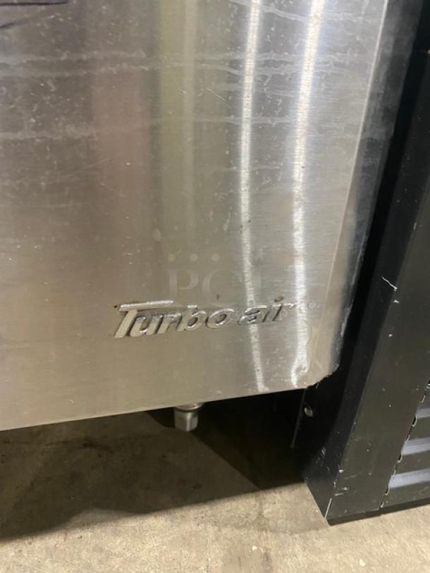 Turbo Air commercial stainless steel single door refrigerated prep table, model MST-28-711S, with visible logo and minor wear.