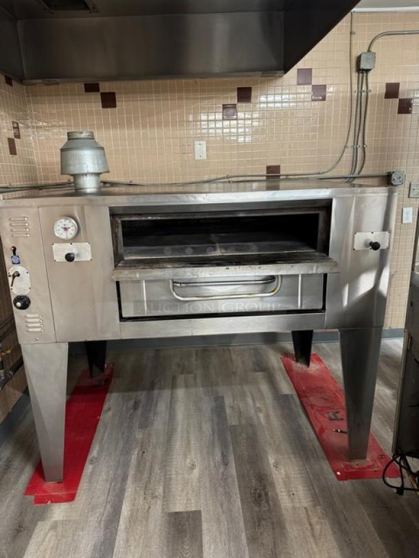 Bakers Pride stainless steel natural gas pizza deck oven with thermostatic control, single-stack, on legs, used condition.
