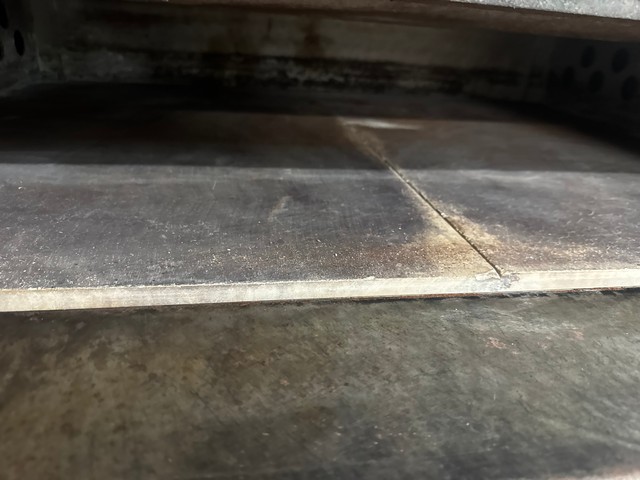 Open deck oven showing cooking stones and high-temperature interior