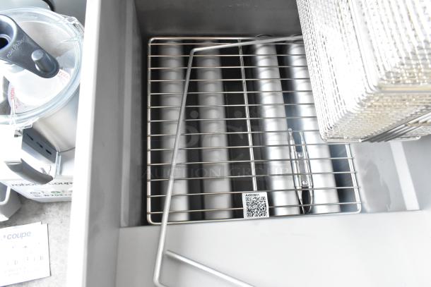 Brand new 2022 Pitco Frialator SG14 stainless steel commercial fryer, natural gas, 110,000 BTU, with two metal baskets.