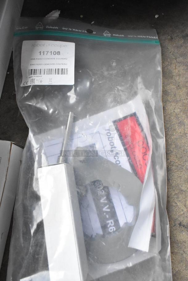 Brand new Robot Coupe R702V.V metal food processor components in packaging, including grater, slicer, label 117108.