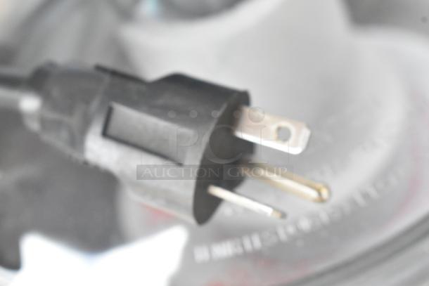 Close-up of a power plug for the Robot Coupe R702V.V food processor, showcasing standard prongs.