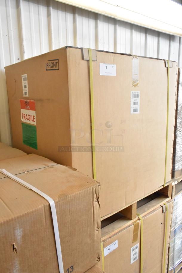Brand new Master-Bilt UF27 stainless steel undercounter freezer in sealed packaging, marked as fragile. 115 volts, 1 phase.