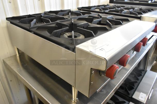 Brand new Therma-Tek TCHP24-4L stainless steel 4-burner propane range, 30,000 BTU, with red control knobs.
