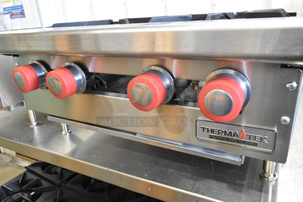 Brand new Therma-Tek TCHP24-4L stainless steel commercial propane 4 burner range, 30,000 BTU, featuring red control knobs.