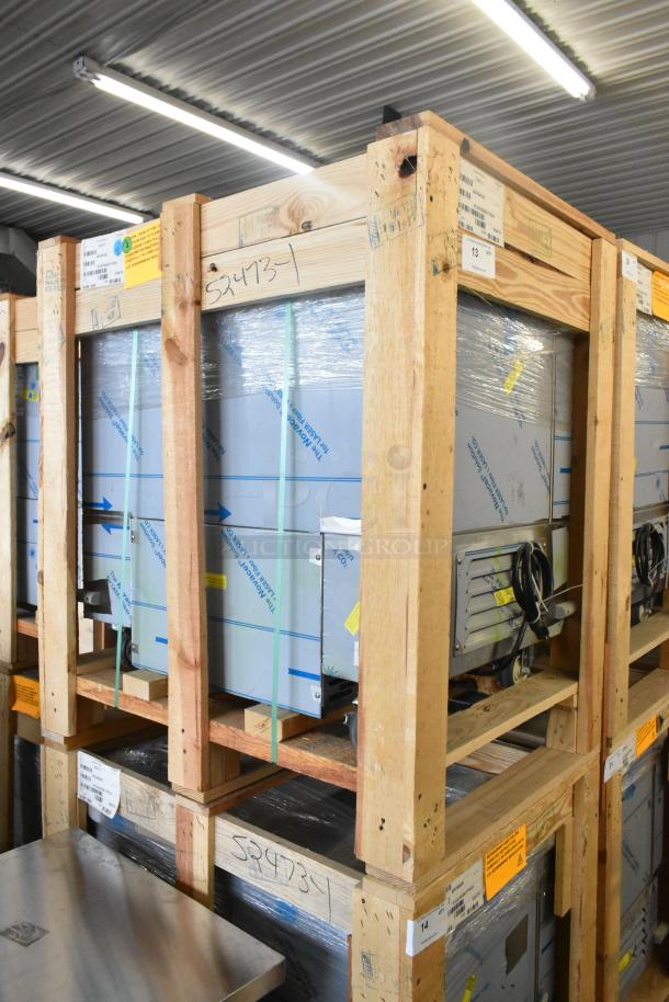 BKI 52473-1 Stainless Steel Commercial Freezer in crate, brand new, on casters, 115V, 1 phase. Model number visible.