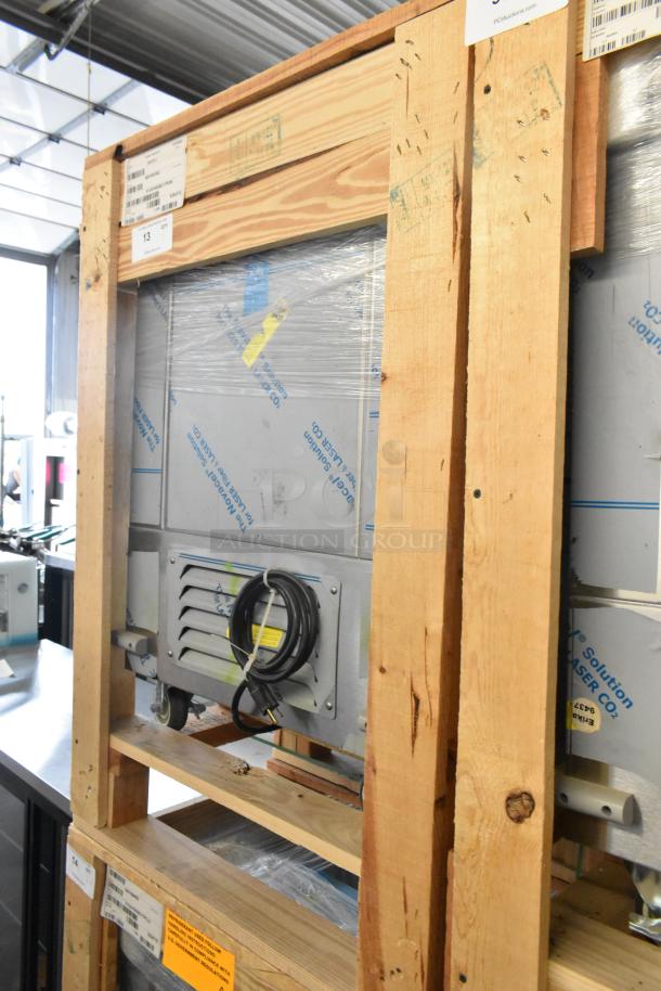 BRAND NEW 2022 BKI 52473-1 stainless steel freezer on casters, 115V, 1 phase. Packaged in wooden crate with visible labels.