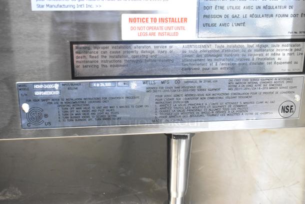 BRAND NEW 2020 Wells HDHP-2430G 4 Burner Stainless Steel Range label showing model, BTU, and installation warnings.