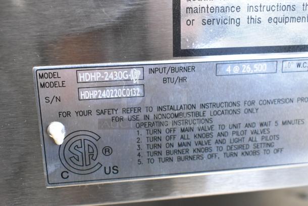 Label on Wells HDHP-2430G stainless steel 4-burner gas range. Shows model, serial number, and input details.