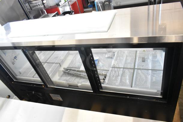 Brand new Avantco 178DLC82HCB 82" black curved glass deli case, 115V, 1 phase. Visible warning label and interior storage space.