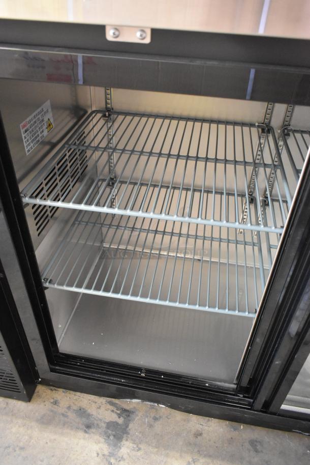 Brand new Avantco 178UBB72SHC 73" black back bar refrigerator with sliding glass doors, shelves, and LED lighting. 115V, 1 phase.