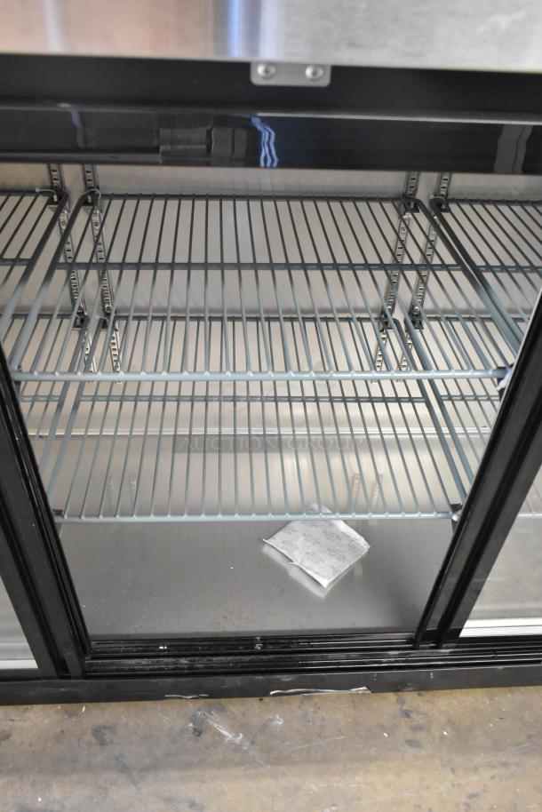 Brand new Avantco 178UBB72SHC 73" black bar refrigerator, sliding glass doors, LED lighting, minor scratches, 115V, 1 phase.