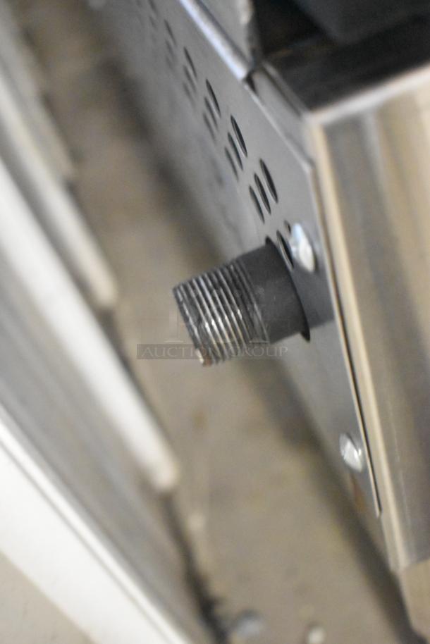 Alt text: Close-up of Therma-Tek TCHP24-4L gas fitting on stainless steel commercial countertop range, new condition.
