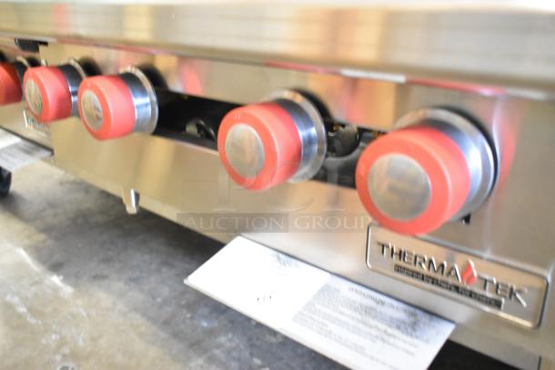Brand new Therma-Tek TCHP24-4L commercial 4-burner propane range. Stainless steel, 30,000 BTU, red knobs, logo visible.