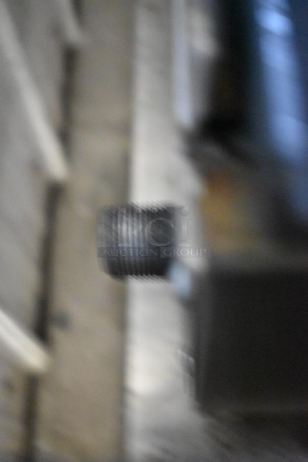 Blurry image of a possible propane gas component related to a Therma-Tek TCHP24-4L range. Difficult to discern details.