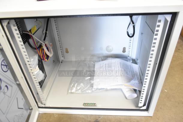 Brand new Hoffmann Spectracool Compact AC, model N170116G010, 115V, 1025 BTU; open interior view with wiring and documents.