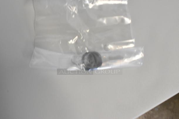 Plastic bag with small black component inside, possibly a part of the Hoffmann Spectracool Compact AC. New condition.