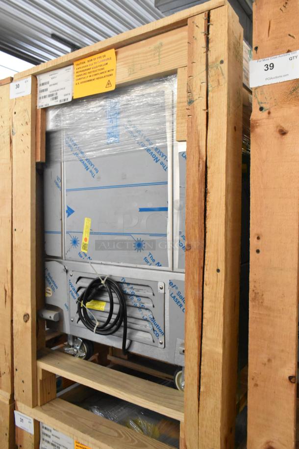 BKI 52473-1 stainless steel commercial freezer, new, on casters, 115 volts, 1 phase, partially wrapped, labels visible.
