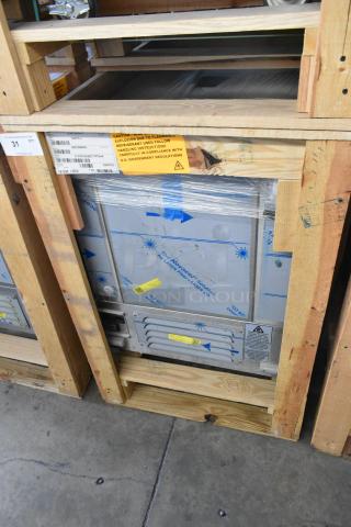 Brand new BKI 52473-1 stainless steel commercial freezer on casters, 115V, 1 Phase. Labeled packaging and warning tags visible.