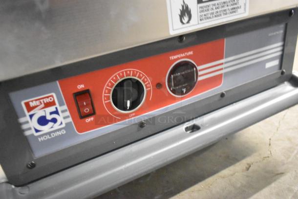 Metro C537-HFS-U-GY heated holding cabinet controls, featuring power switch and temperature dial. Model details on label.