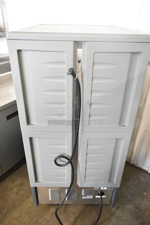 Brand new Metro C537-HFS-U-GY heated holding cabinet with solid door, on casters, 120V, showing power cord and label.