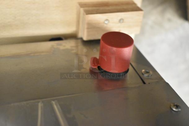 Close-up of the Cooking Performance Group CPG CR-CPG-48-NL Charbroiler's stainless steel surface with a red control knob.
