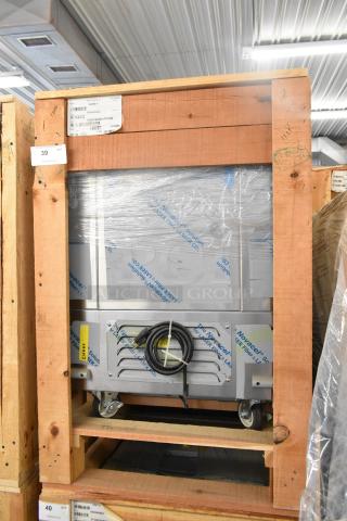 Brand new BKI 52473-1 stainless steel commercial freezer, on casters, in packaging. 115V, 1 phase. Industrial setting.