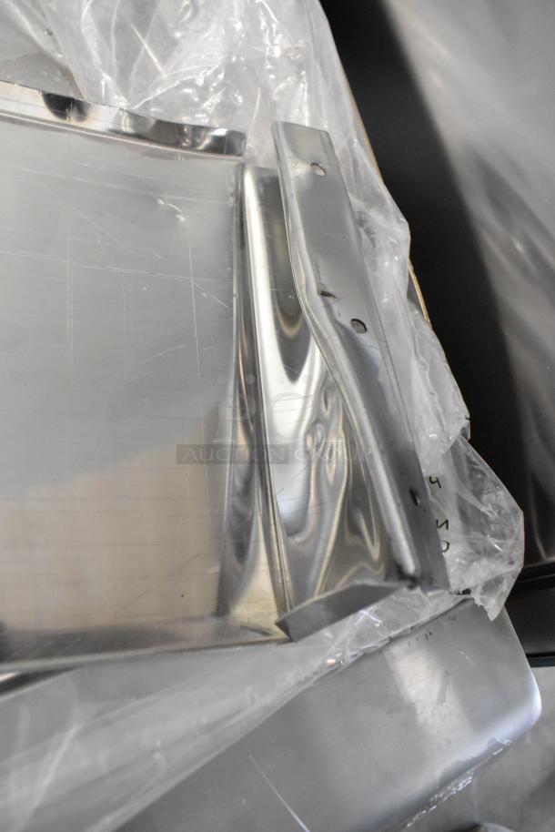 Stainless steel surface of a 2024 CPG GM-CPG-60-NL countertop griddle, showing minor scratches under protective film.