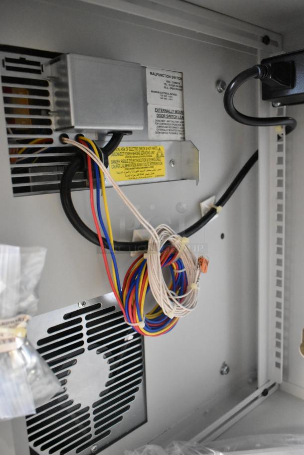 Hoffmann Spectracool Compact AC N170116G010, 115V, 1025 BTU, new condition, visible wiring and labels inside unit.