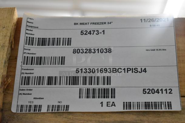 "Label on BKI 52473-1 stainless steel commercial freezer, showing model, serial, condenser numbers, and date 11/26/2021."