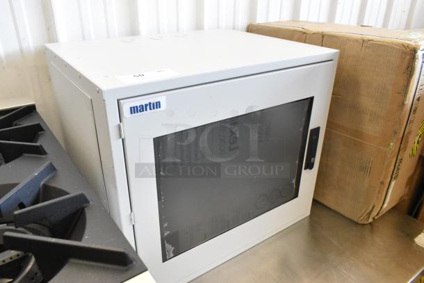 Brand new Martin white metal box with glass front, labeled "martin," in pristine condition, ideal for storage or display.