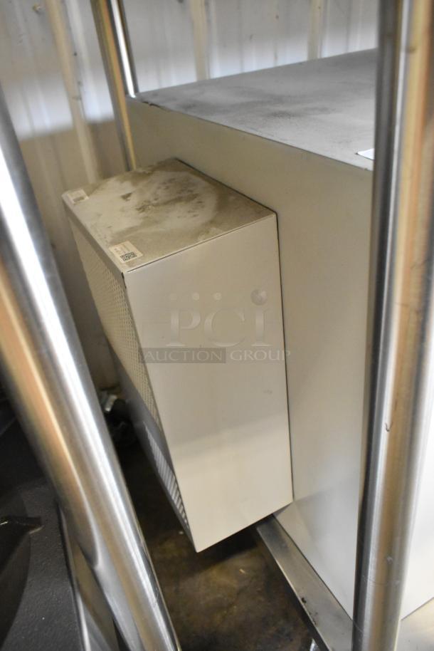 Brand new Telege white metal case with a locked door. Minor dust visible on the surface.