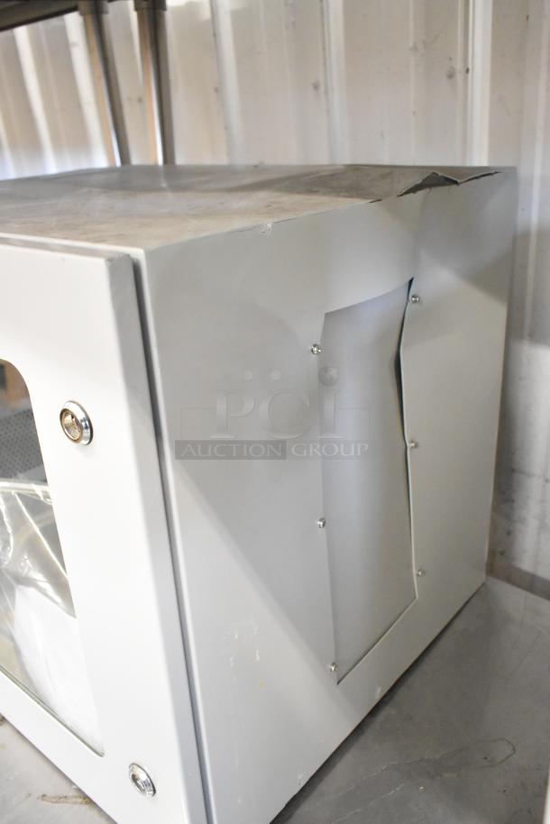 Brand new Telege white metal case with locked door. Features sturdy construction and visible damage on top corner.