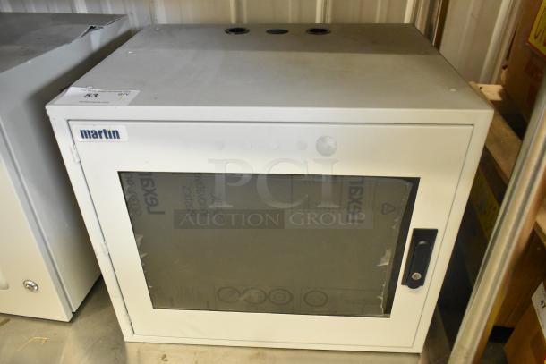 Brand new Martin white metal enclosure with glass door, brand label, and lockable handle. Ideal for secure storage.