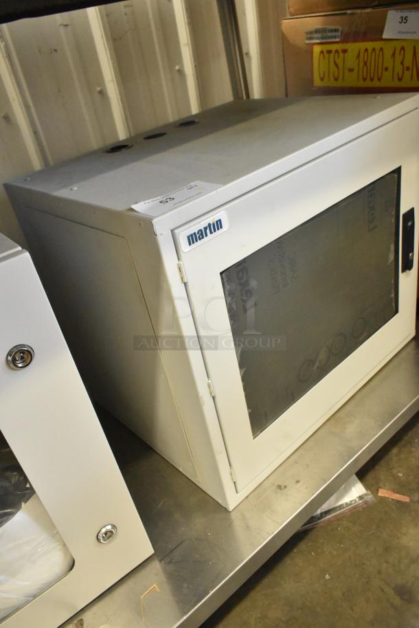 Brand new Martin white metal enclosure with glass door, model details visible. Suitable for secure storage needs.