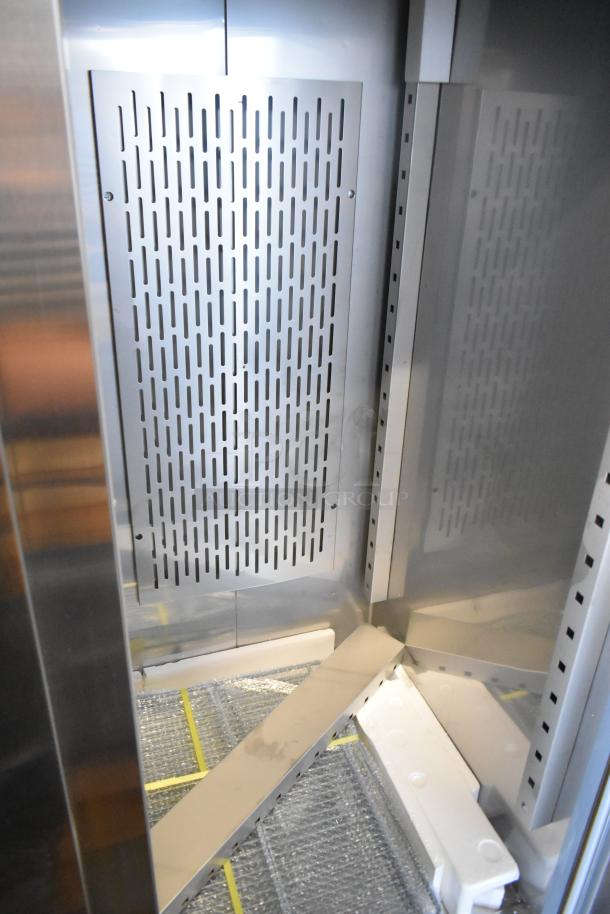 Brand new Avantco 178SS3FHC stainless steel commercial freezer interior. Features poly coated racks, commercial casters.