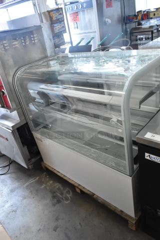 Brand new Avantco 193BC48HCW 48" commercial refrigerated bakery display case with curved glass. Glass shows visible damage. 115V, 1 phase.