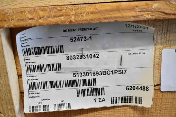 Label showing BKI commercial freezer model 52473-1, serial 8032831042, with commercial casters, 115V, 1 phase.